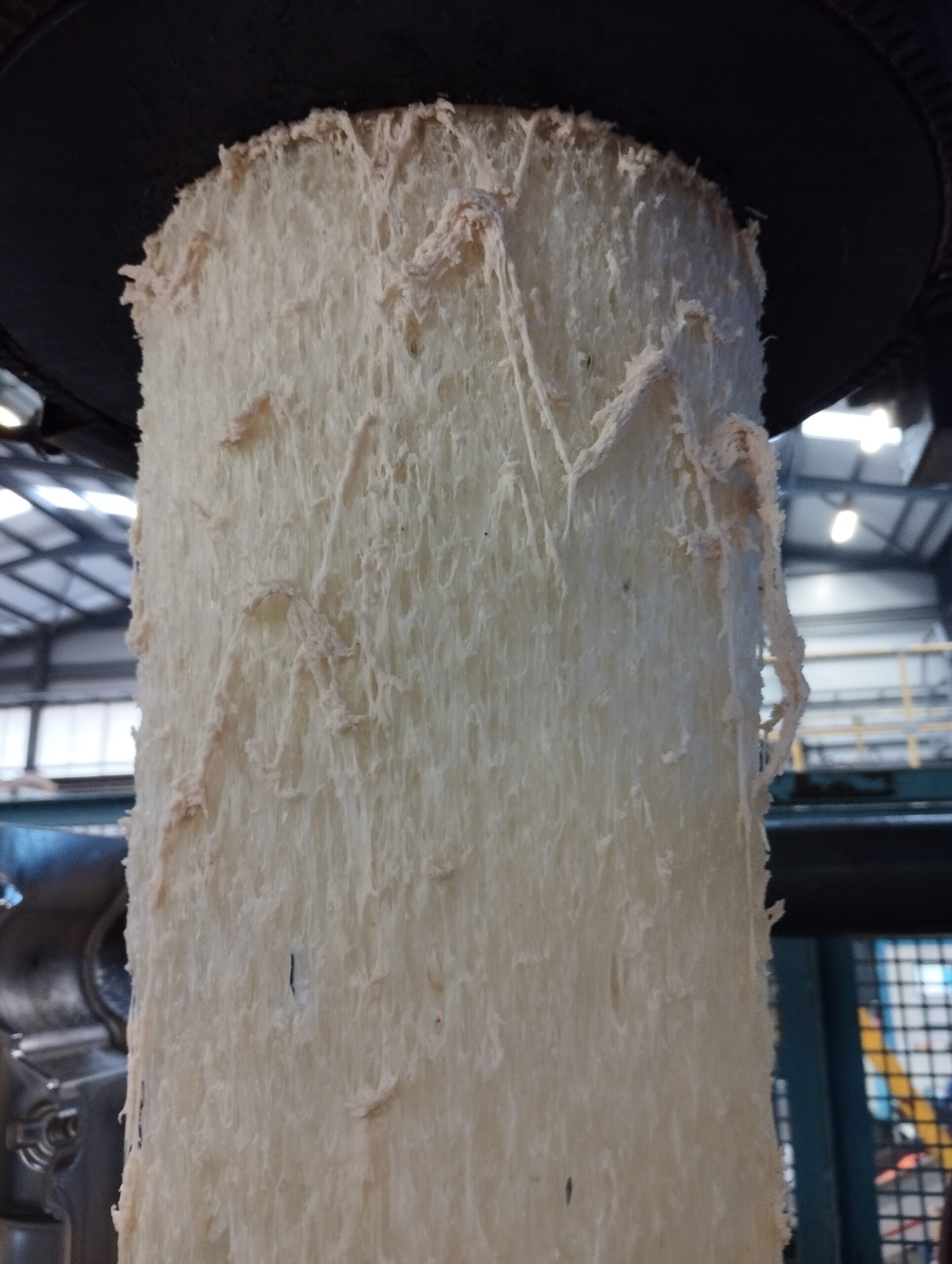 Close-up of rough plastic material after purge compound for plastics, showing carbon removal and extrusion cleaning results